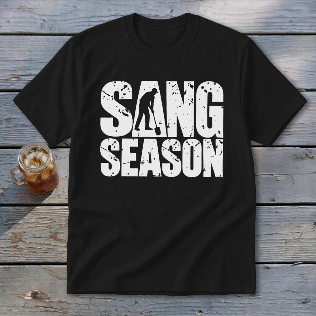 A black t-shirt with distressed white text reading SANG SEASON, featuring a person digging with a shovel.