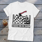 White t-shirt with graphic of stacked firewood and axe, reading "STACKED FOR THE SEASON".