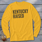 Yellow long-sleeve shirt with "KENTUCKY RAISED" text in black.