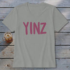 Light gray V-neck t-shirt with pink "YINZ" text and a glass of iced drink.
