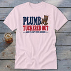 Pink t-shirt with "Plumb Tucked Out - And It Ain't Even Dinner" text and rocking chair graphic.