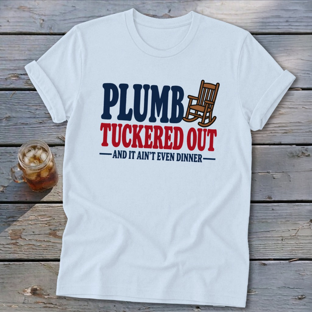 White t-shirt with "PLUMB TUCKED OUT -AND IT AIN'T EVEN DINNER-" text and rocking chair graphic.
