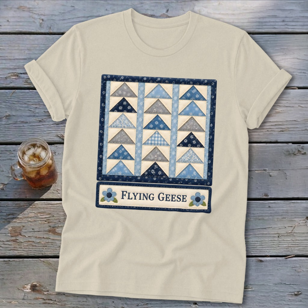 Cream t-shirt with a blue and grey flying geese quilt pattern and "Flying Geese" text.