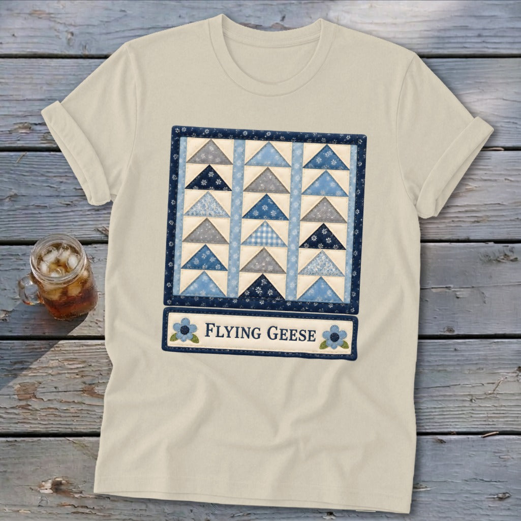 Cream t-shirt with a blue and grey flying geese quilt pattern and "Flying Geese" text.