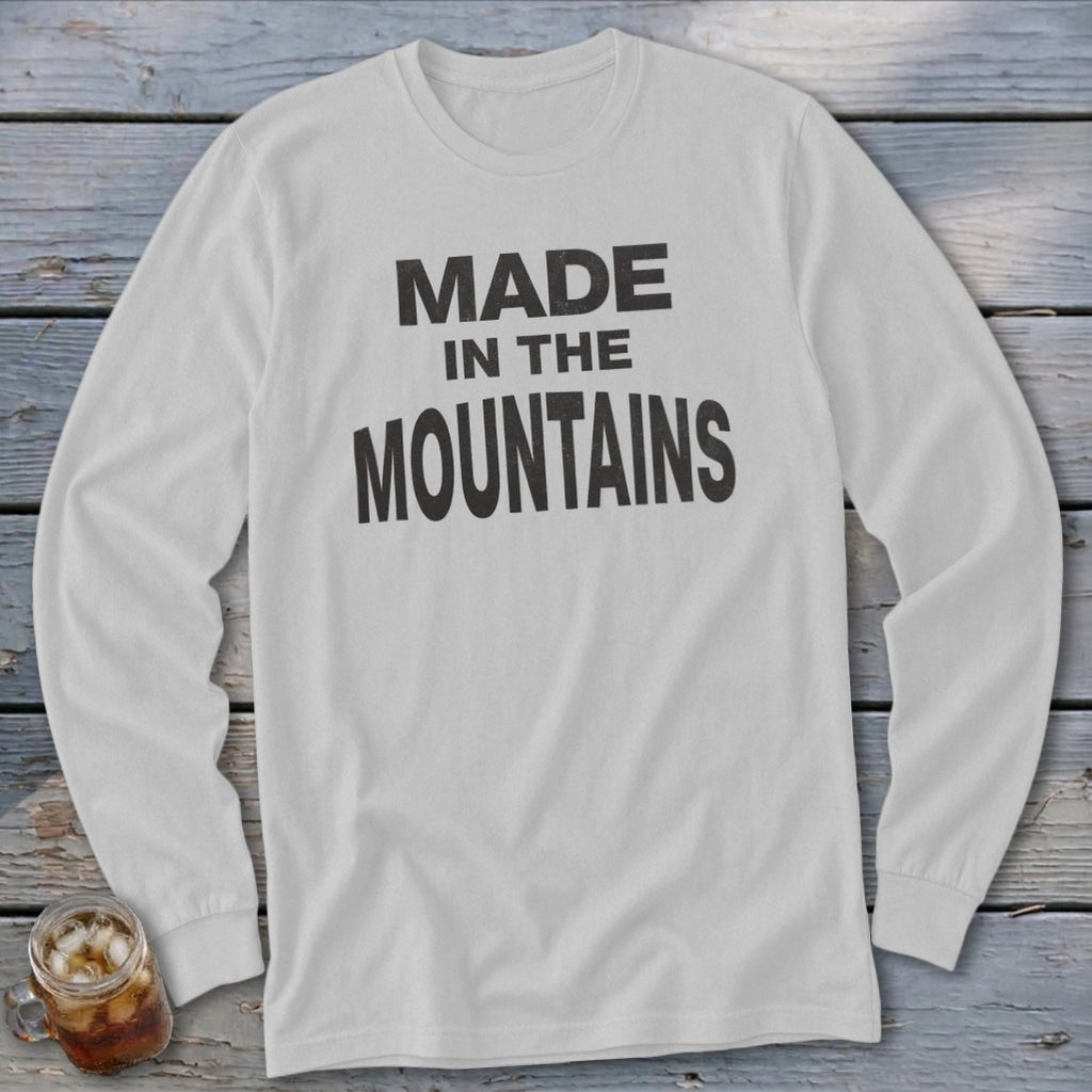 White long-sleeve t-shirt with black text reading "MADE IN THE MOUNTAINS".
