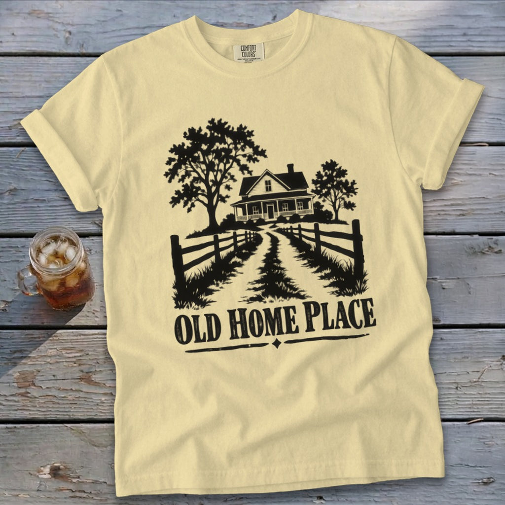 Yellow t-shirt with a black graphic of a farmhouse, trees, fence, and the text "OLD HOME PLACE".