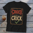Black t-shirt with a distressed sign reading "Creek" crossed out and "Crick" with a checkmark.