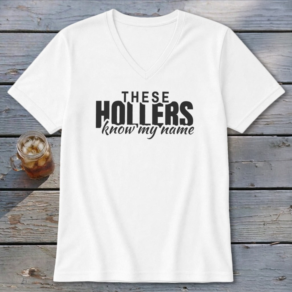 White v-neck t-shirt with black text "THESE HOLLERS know my name".