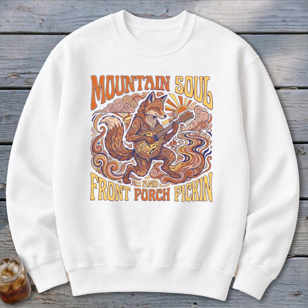 White sweatshirt with "Mountain Soul" and "Front Porch Pickin'" text and a fox playing guitar.