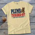 Yellow t-shirt with "PLUMB TUCKERED OUT AND IT AIN'T EVEN DINNER" text.