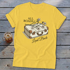 Yellow t-shirt with suitcase and flowers graphic, reading "All Roads Lead Back".