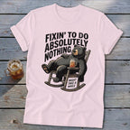 Light pink t-shirt featuring a cartoon black bear relaxing in a rocking chair with text.