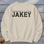 Cream sweatshirt with black text "LOOKING A LITTLE JAKEY"