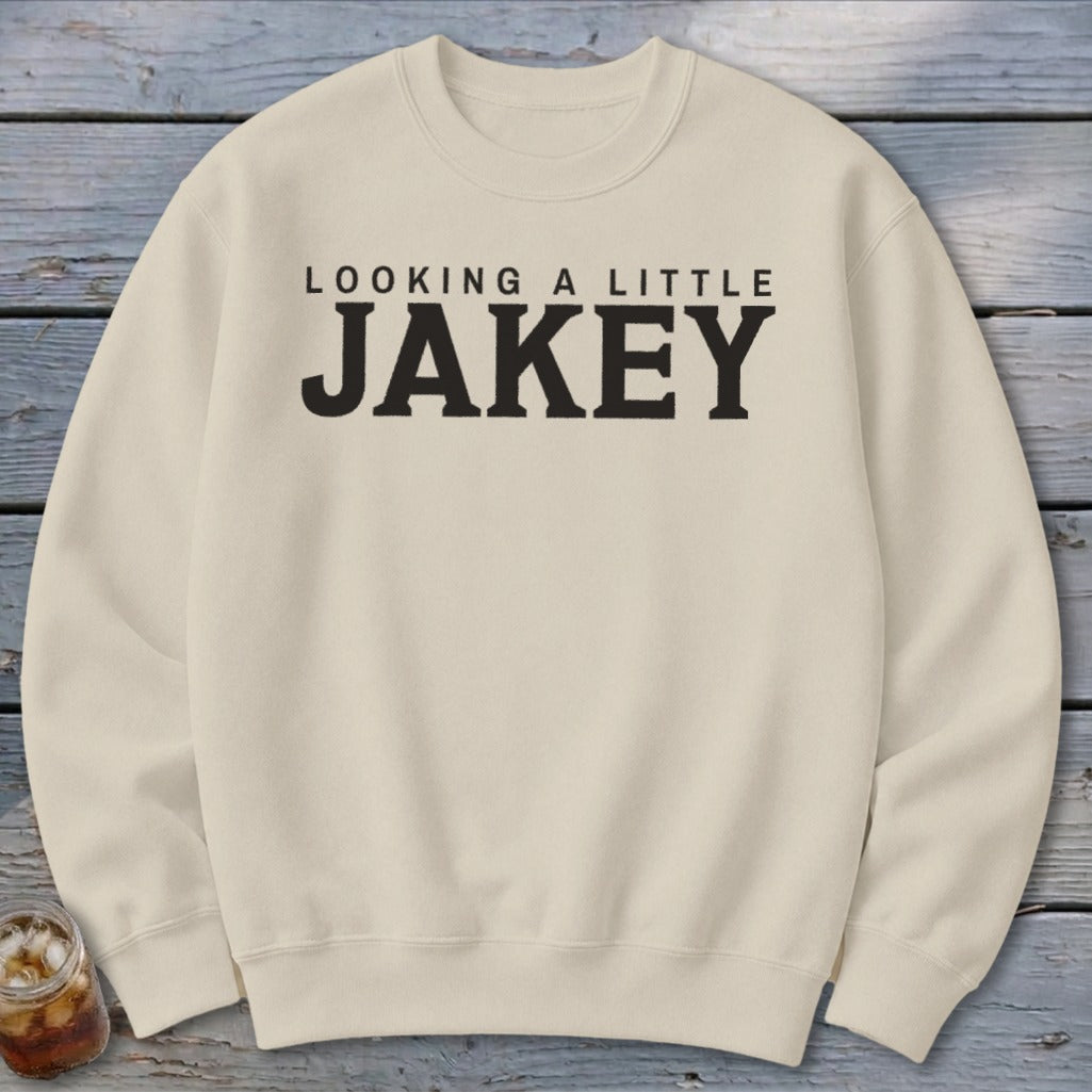 Cream sweatshirt with black text "LOOKING A LITTLE JAKEY"