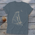 Bear sitting on rock looking up at moon and stars graphic on a t-shirt.