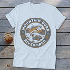 White t-shirt with "Mountain Born River Bred" text and a jumping trout graphic.