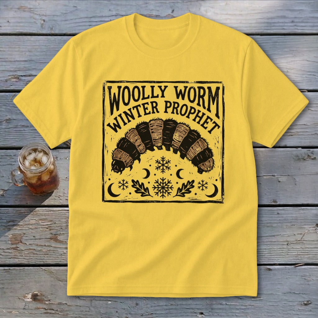 A yellow short-sleeved t-shirt with a square black illustration of a woolly worm and snowflakes.