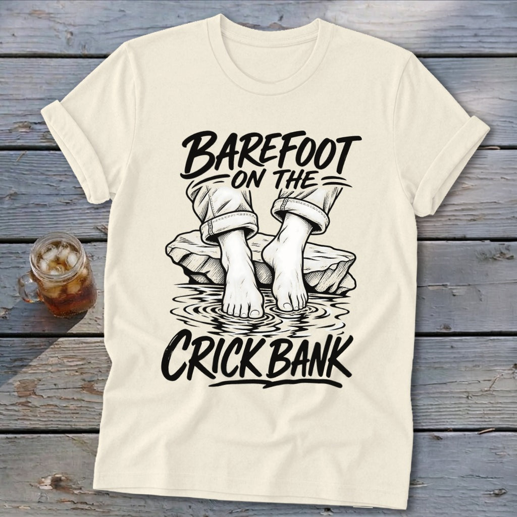 T-shirt graphic: barefoot on the crick bank text with feet in water.