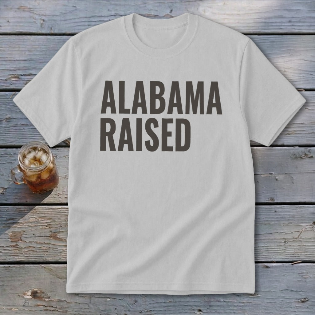 Light grey t-shirt with "ALABAMA RAISED" text in dark grey.