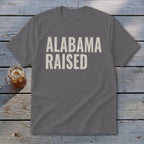 Gray t-shirt with "ALABAMA RAISED" printed in cream lettering.
