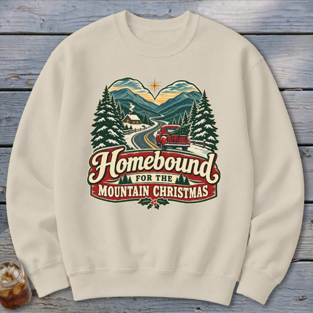 Sweatshirt with "Homebound for the Mountain Christmas" graphic featuring a red truck and snowy landscape.