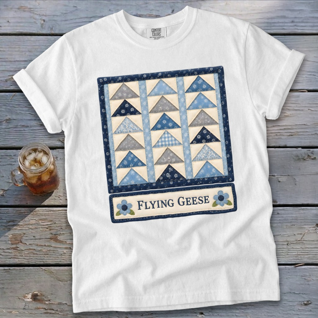White t-shirt with "Flying Geese" quilt pattern and text graphic.
