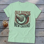 Light green t-shirt featuring a banjo graphic and text that reads Old Sounds New Ground.