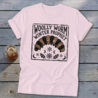 Light pink crewneck t-shirt featuring a black block-print graphic of a woolly worm and text reading Woolly Worm Winter Prophet.