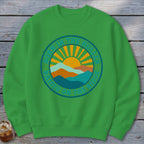 A green crewneck sweatshirt featuring a circular retro graphic with mountains, a sun, and text that reads BORN IN THE HOLLER RAISED ON THE RIDGE.