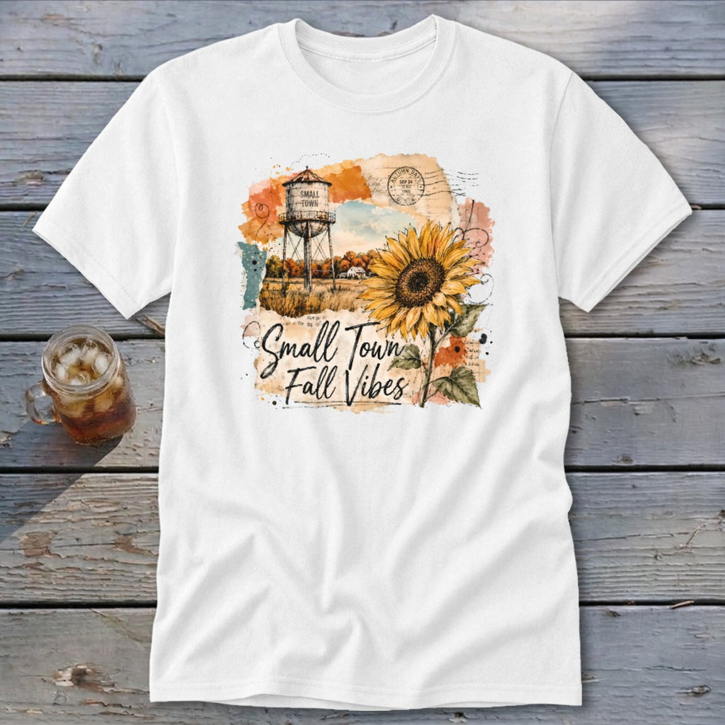 White t-shirt with "Small Town Fall Vibes" text and watercolor artwork of a sunflower and water tower.