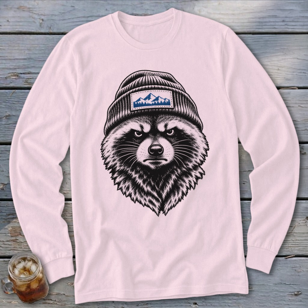 Long-sleeve pink shirt with a detailed drawing of a raccoon wearing a beanie with a mountain patch.