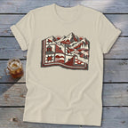 A light beige t-shirt featuring a red, black, and white graphic of mountains and a quilted landscape.