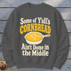 Charcoal gray crewneck sweatshirt featuring the text Some of Y'all's Cornbread Ain't Done in the Middle.
