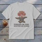 White t-shirt with anvil, blooming plant, and text "FORGED IN FIRE ROOTED IN STONE".