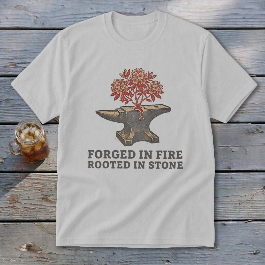 White t-shirt with anvil, blooming plant, and text "FORGED IN FIRE ROOTED IN STONE".