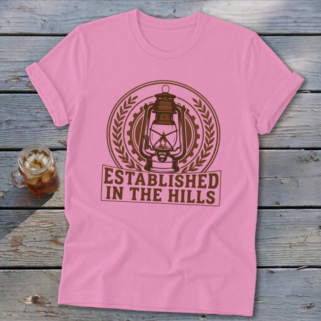 Pink t-shirt with brown "Established in the Hills" text and lantern graphic.