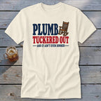 Cream t-shirt with "PLUMB TUCKED OUT" and rocking chair graphic.