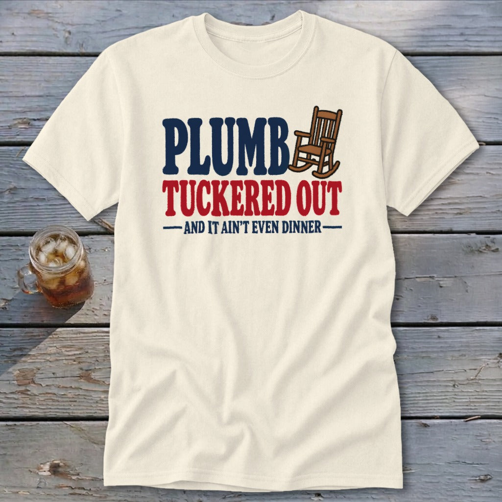 Cream t-shirt with "PLUMB TUCKED OUT" and rocking chair graphic.