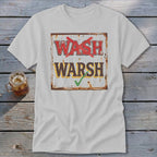 Light gray t-shirt with a distressed graphic of a sign featuring the words WASH with a red X and WARSH with a green checkmark.