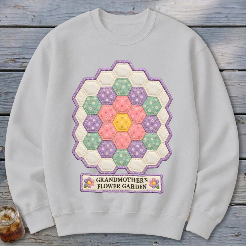 White sweatshirt with hexagonal quilt design and text "GRANDMOTHER'S FLOWER GARDEN".