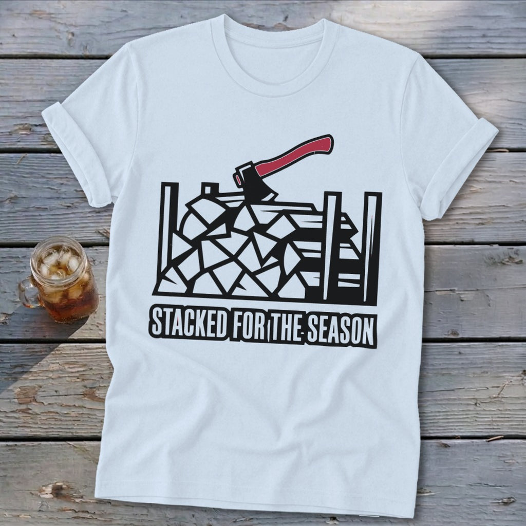 White t-shirt with black graphic of stacked firewood and axe, "Stacked for the Season" text.