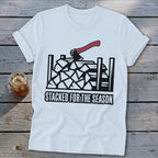 White t-shirt with black graphic of stacked firewood and axe, "Stacked for the Season" text.