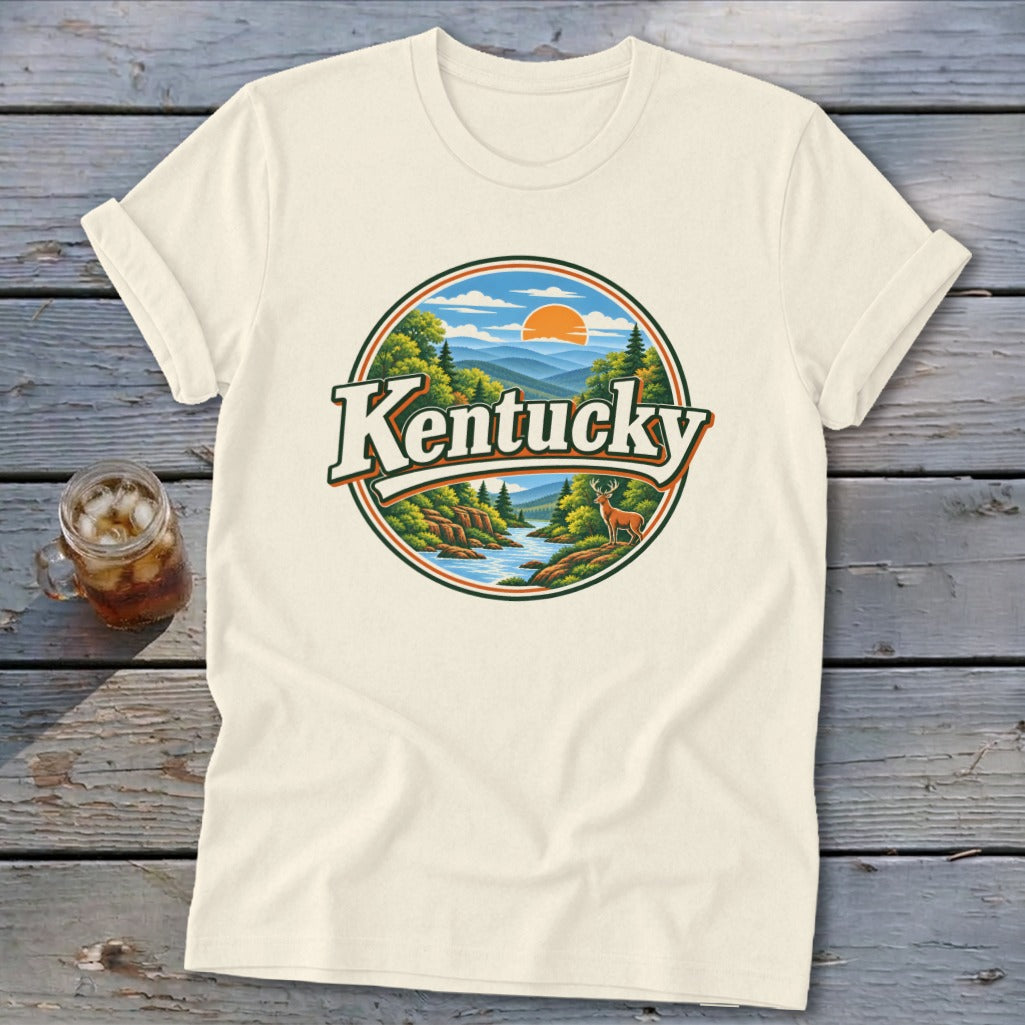 Cream t-shirt with circular Kentucky mountain landscape graphic featuring deer and river.