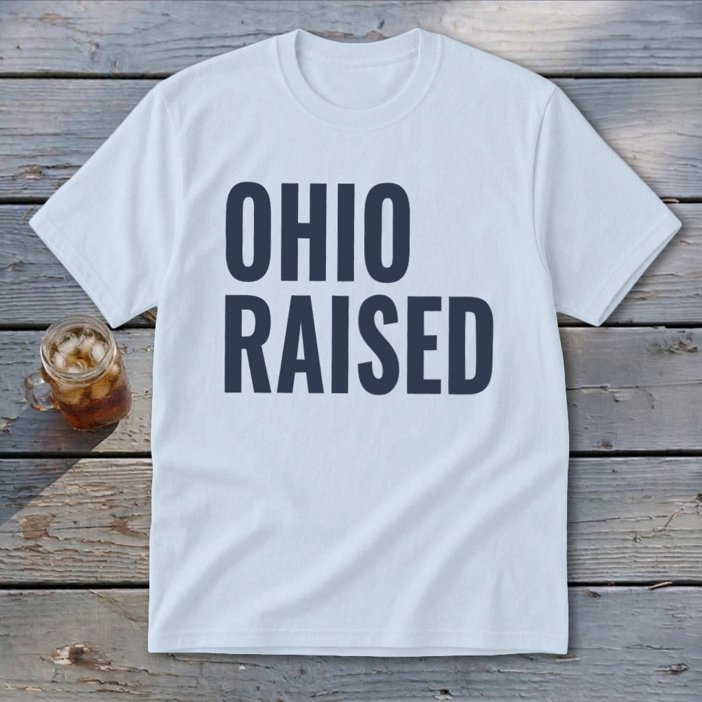 Light blue t-shirt with dark blue text reading "OHIO RAISED".