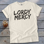 Cream t-shirt with "LORDY MERCY" in black brushstroke font.
