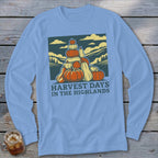 Light blue long-sleeve t-shirt featuring a graphic of stacked pumpkins, hills, and the text Harvest Days in the Highlands.
