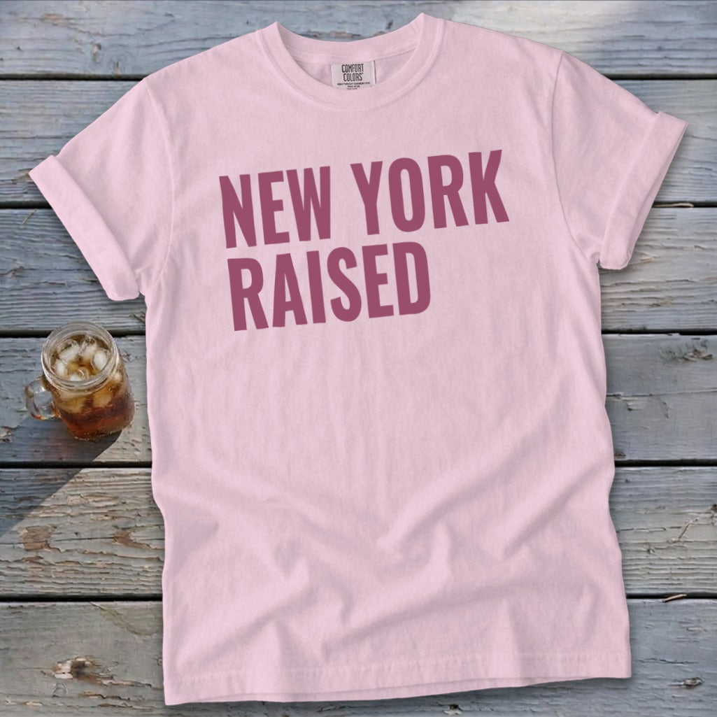 Light pink t-shirt with "NEW YORK RAISED" text in maroon.