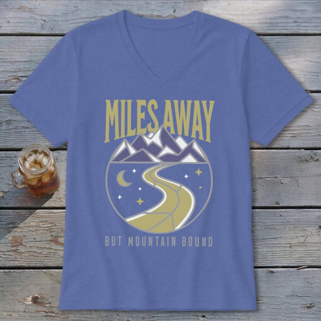 Purple t-shirt with "MILES AWAY BUT MOUNTAIN BOUND" text and mountain road graphic.