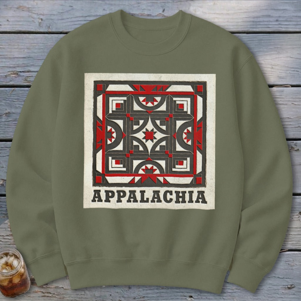An olive green crewneck sweatshirt featuring a square geometric quilt block graphic with the text Appalachia below.