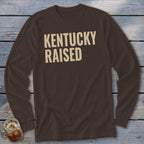 Brown long-sleeve shirt with "Kentucky Raised" text in cream.